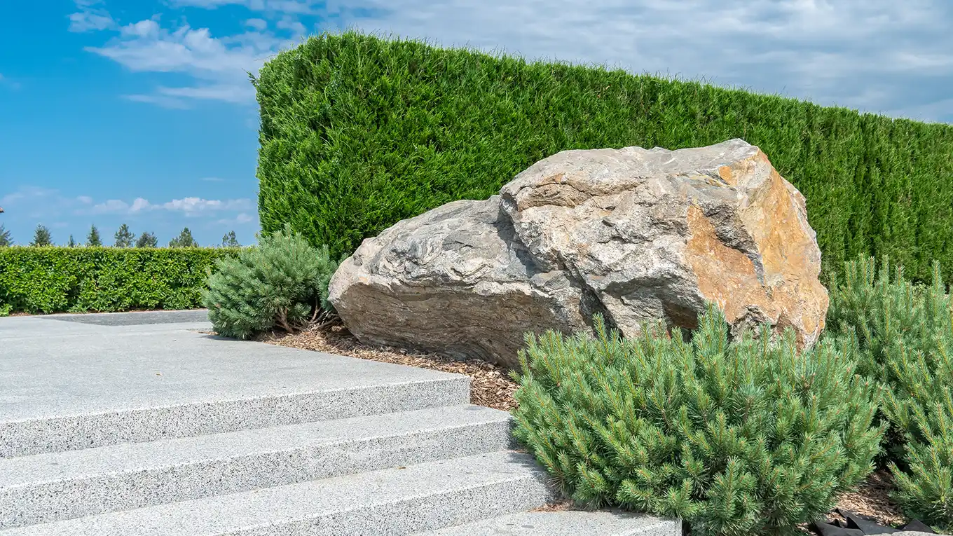 Landscape boulders and stone stacked across the Olimar Stone yard in Miami